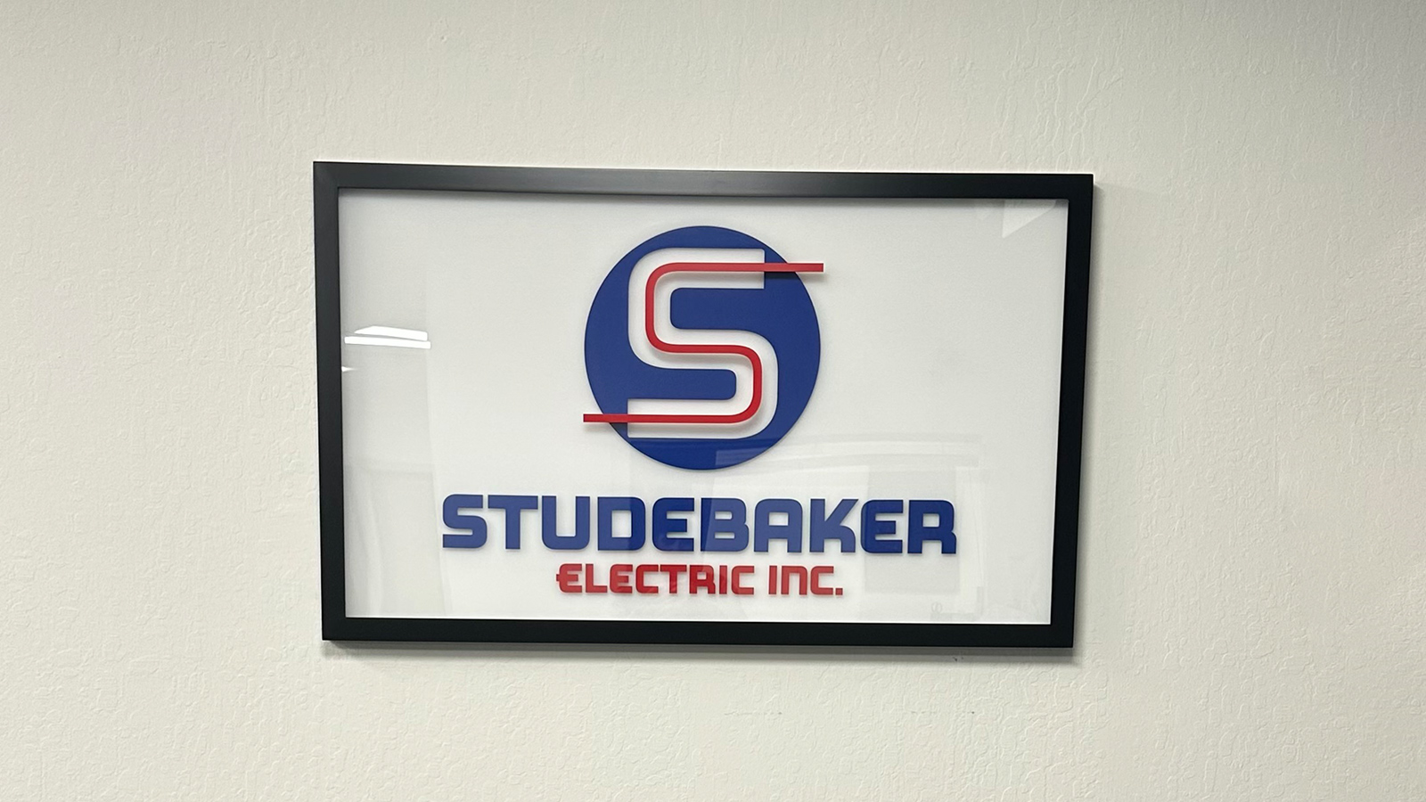 studebaker electric inc framed panel on interior wall